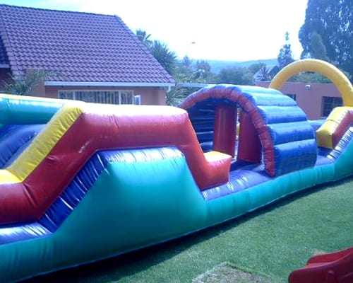 Vibrant water slide obstacle course on grass