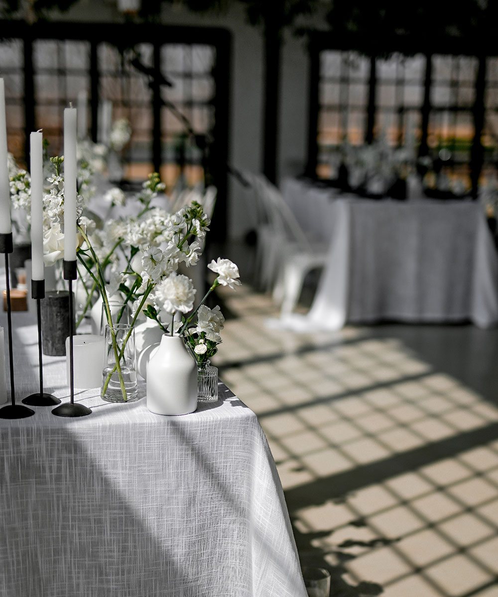 Table setup with flowers and candles in a bright room