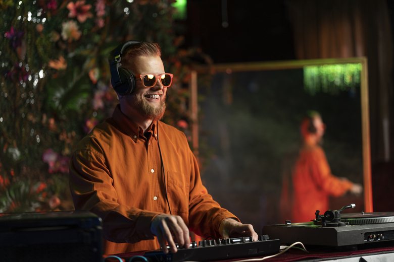 DJ wearing headphones and sunglasses at an event
