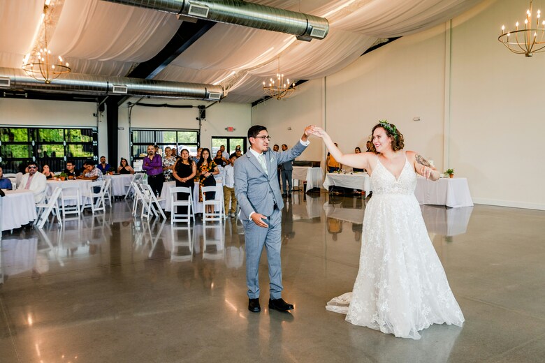 Couple dancing on a polished floor in an event venue
