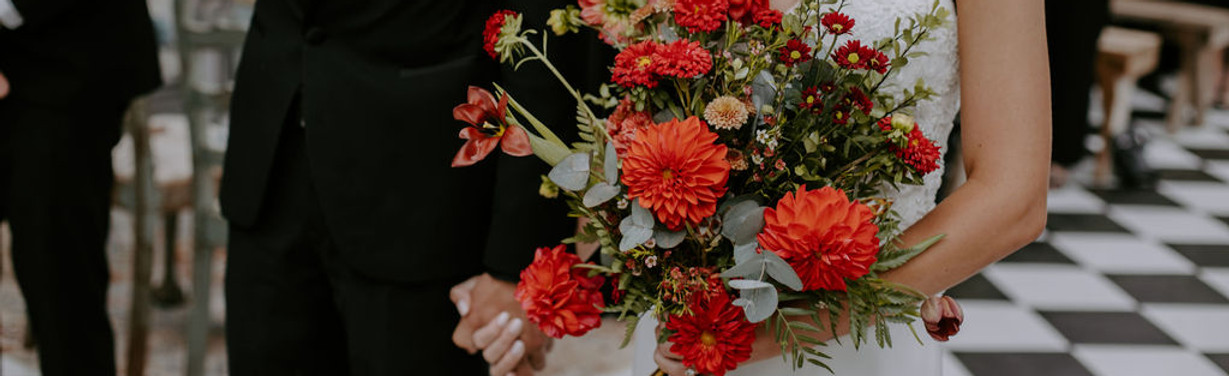 Wedding bouquet with red flowers and greenery